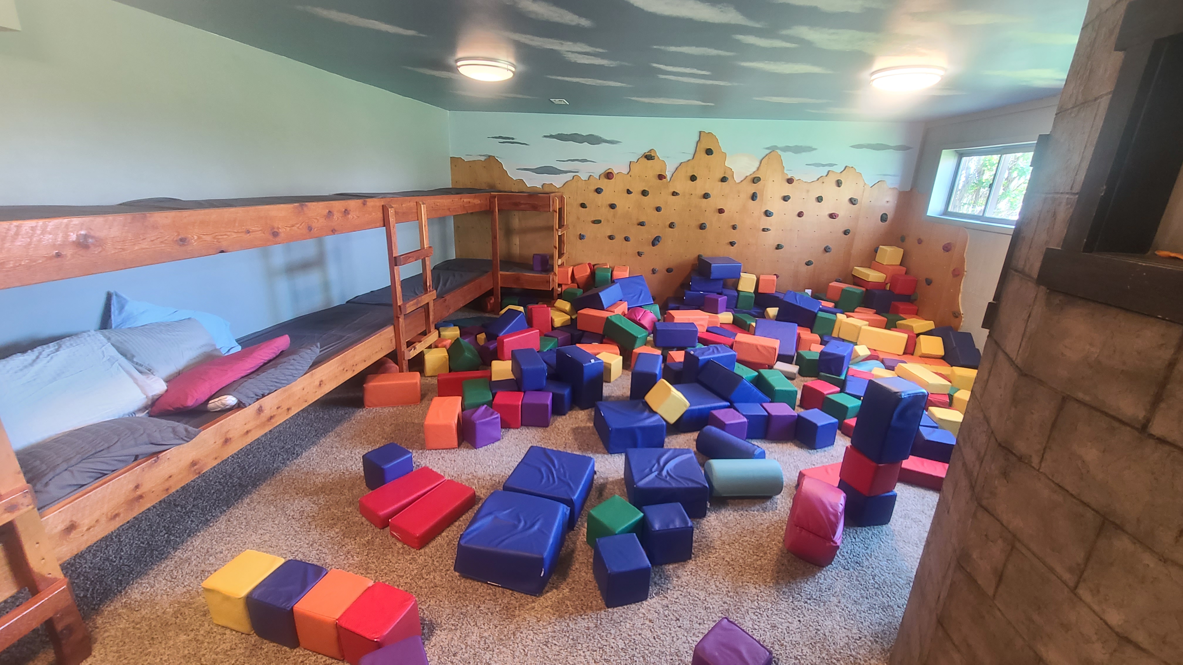 Bunk room and indoor playroom at Three Peaks Lodge