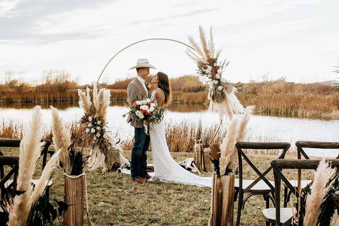 Outdoor wedding ceremony by the pond at Three Peaks Lodge