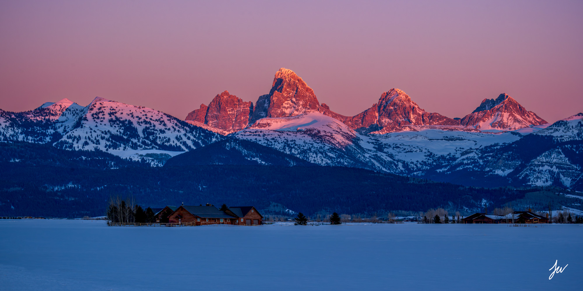 Snowy Teton peaks at sunrise over Idaho country