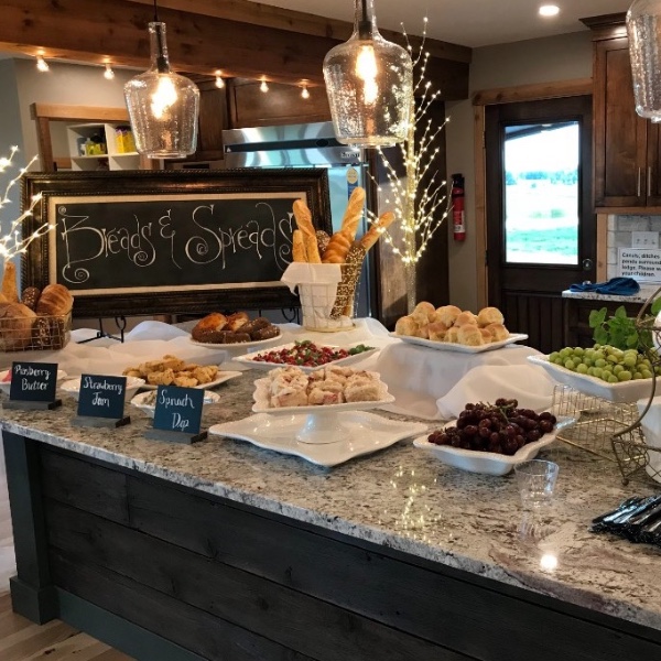 Sunday breakfast buffet on the lodge kitchen island — breads, spreads, fruit, and drinks